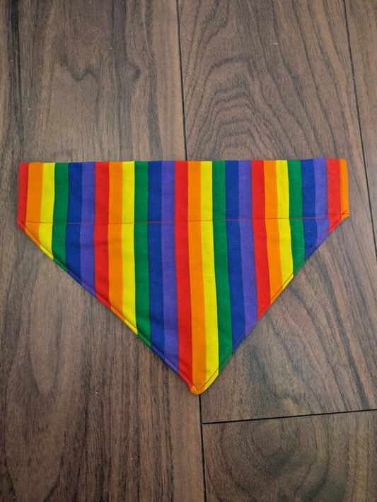 Eco friendly dog bandana that slips over the collar. It has vertical rainbow stripes and is top stitched around the edge.