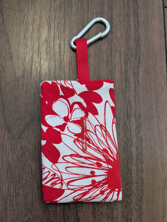 Upcycled Refillable Dog Poo Bag Holder – Clip-on Dispenser, Eco-Friendly & Handmade in the UK from recycled fabric. A dog walking essential in red and white floral print complete with button hole and metal clip.