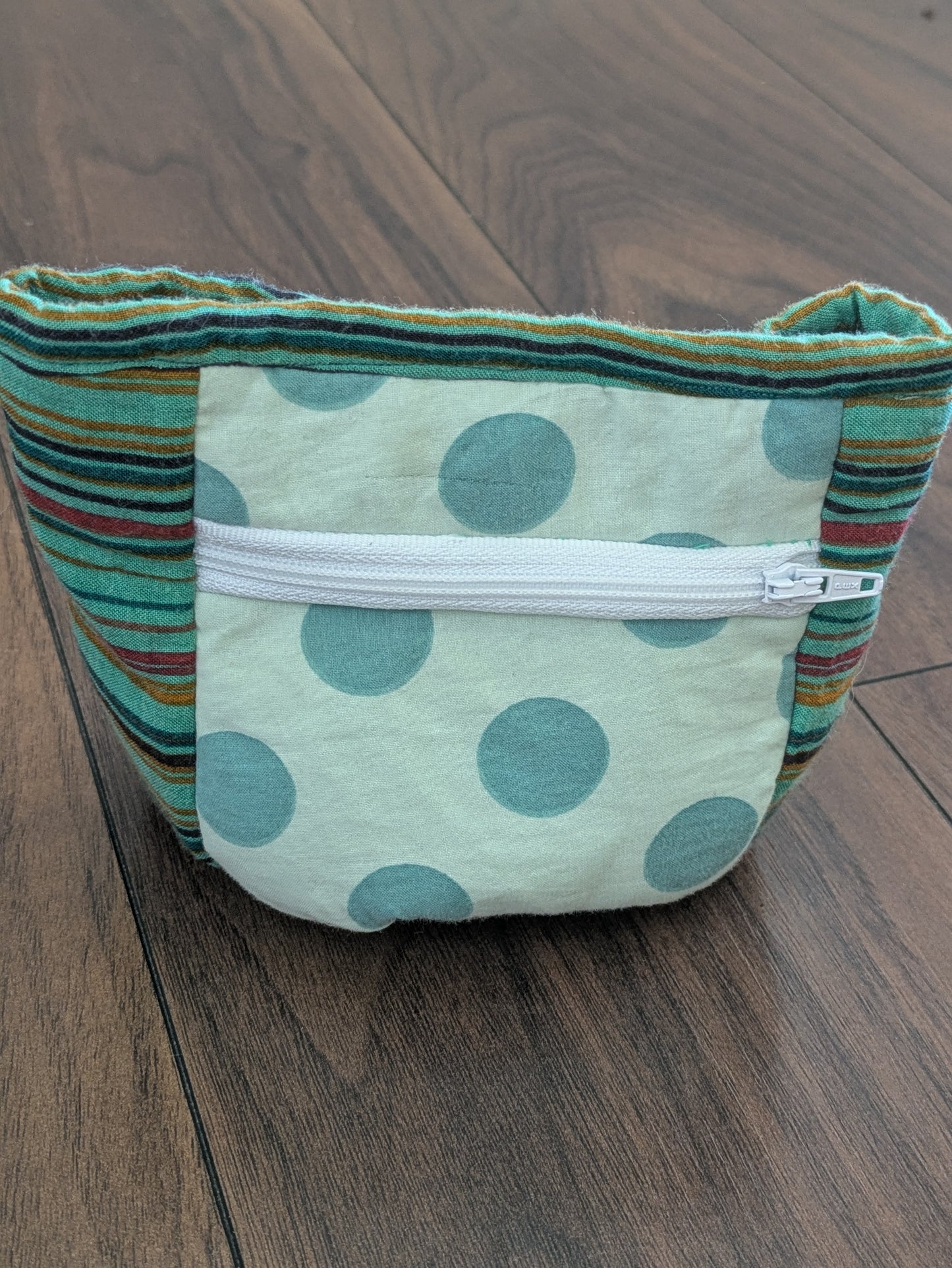 Upcycled dog treat pouch with two preloved fabrics, mint green with spots and multicolour stripes. Front zip pocket, wipeable lining and clip or loop attachment for hands free training. 